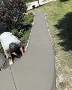 Crew member forming a curved concrete sidewalk in Apex, NC